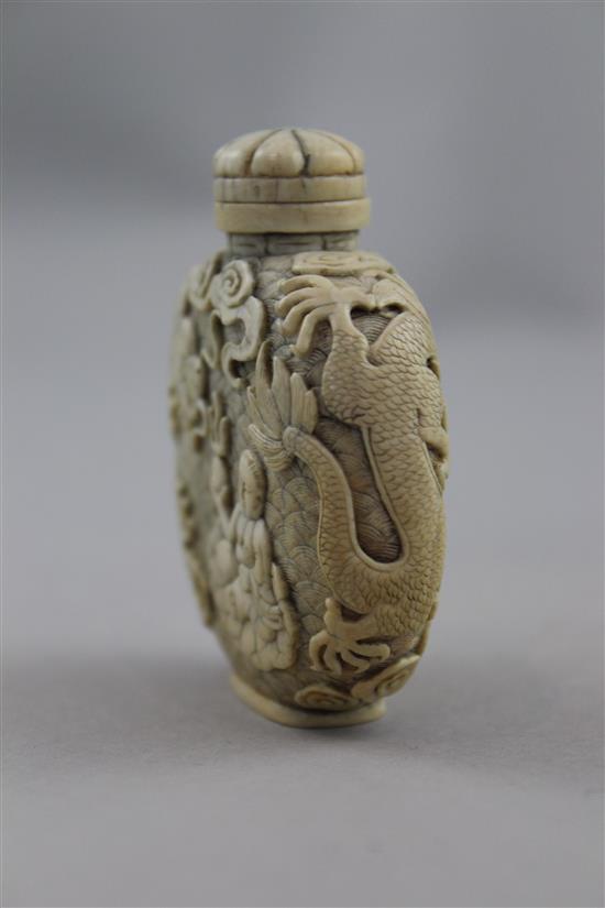 A Chinese ivory dragon and luohan snuff bottle, 1800-1850, 6.2cm